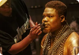 Actor receiving makeup before filming.